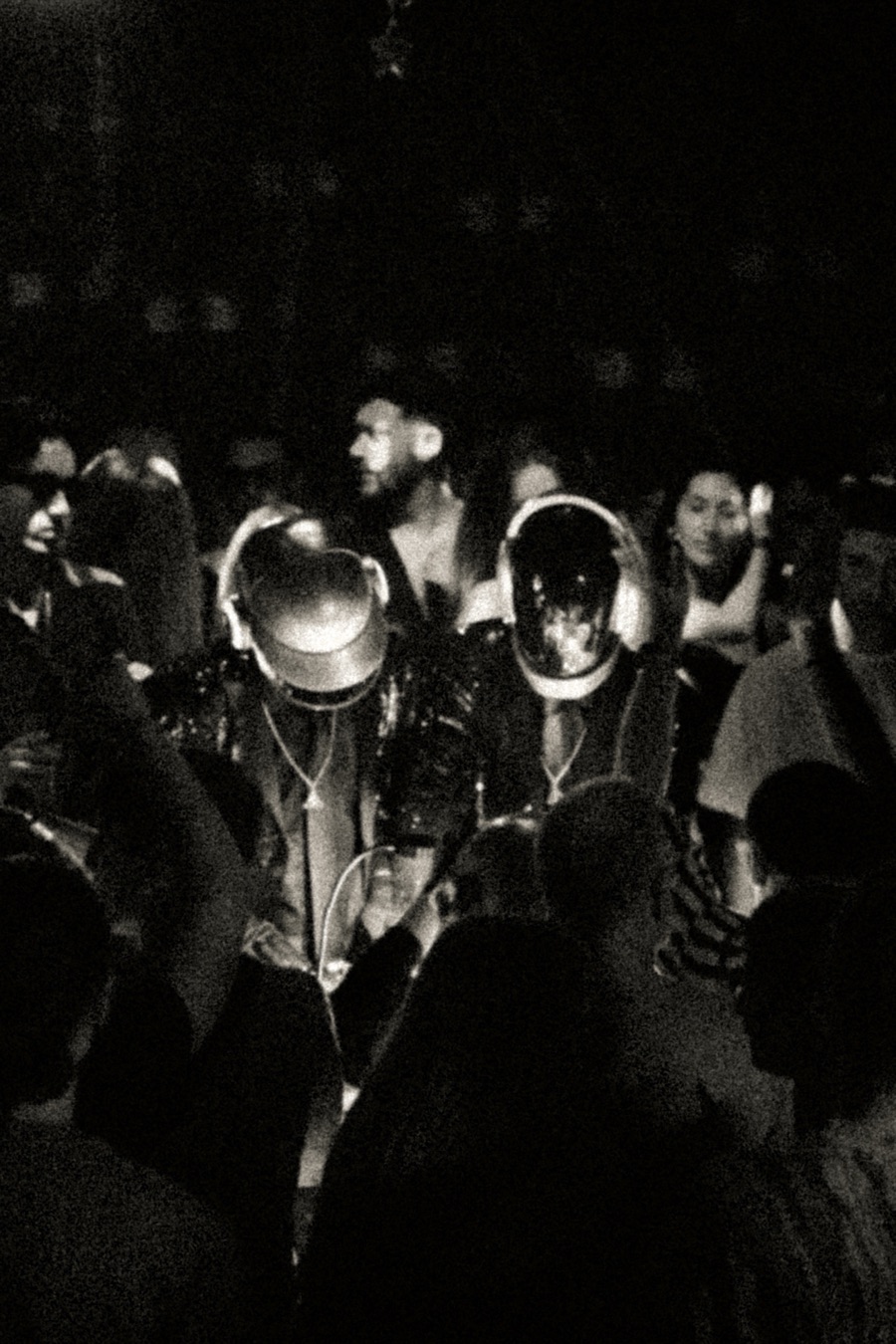 Black-and-white shot of ALIVE surrounded by the crowd